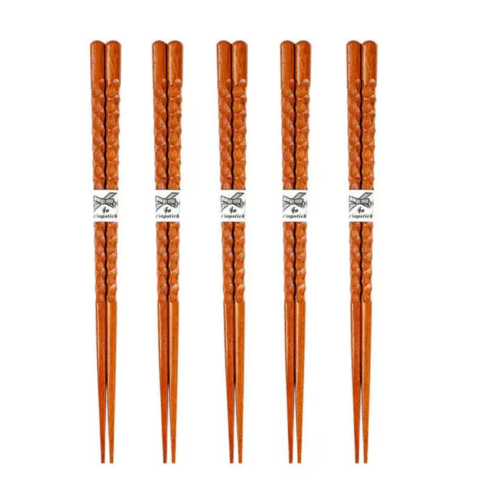 Set of five pairs of wooden chopsticks on a white background