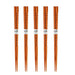 Set of five pairs of wooden chopsticks on a white background