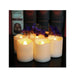 Set of six white candles with a blurred background