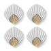 Four white coasters with gold shell designs on a white background