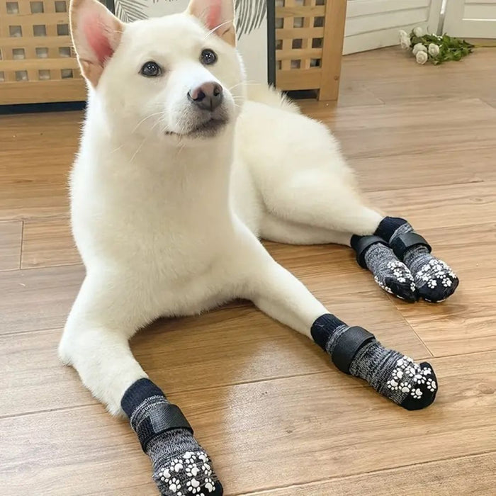 Medium-sized black dog ankle socks with paw-print grip pads for anti-slip traction. Adjustable black straps ensure a secure fit. Waterproof, warm, and designed for indoor pet comfort.
160000554185312393444