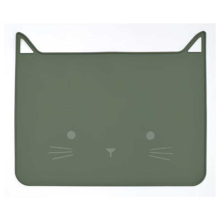 Green silicone placemat shaped like a cat’s face with ears, eyes, nose, and whisker details.


