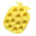 Yellow pineapple-shaped ice cube tray on a white background
