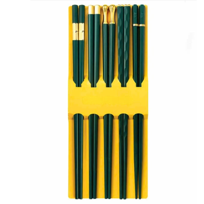 Set of green pens with gold accents on a yellow background