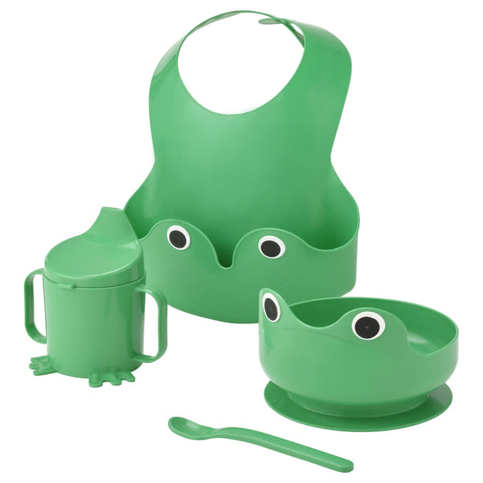 Green children's feeding set with bib, cup, bowl, and spoon on a white background