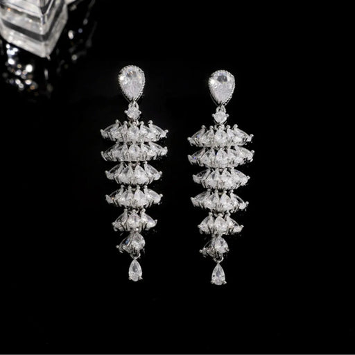 Pair of elegant, dangling earrings with teardrop-shaped gems and layered clear stones on a black background – 1600002193457 14066565