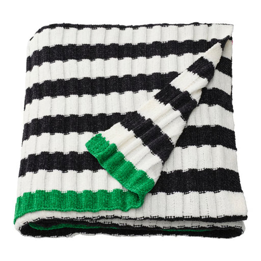 Black and white striped blanket with green trim on a white background