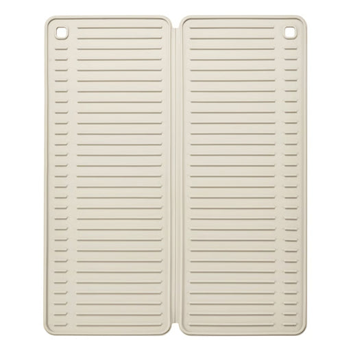 Two beige silicone mats with slotted design on a white background