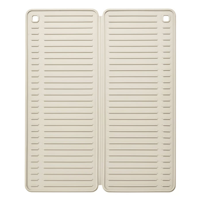 Two beige silicone mats with slotted design on a white background
