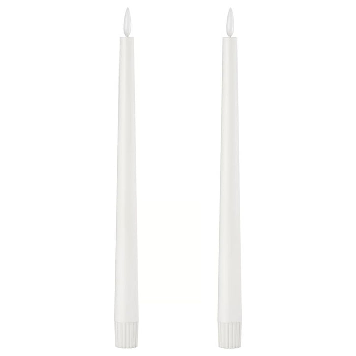 Pair of IKEA SMÅLOM LED taper candles in white with ribbed bases and flame-shaped tips, shown unlit against plain background