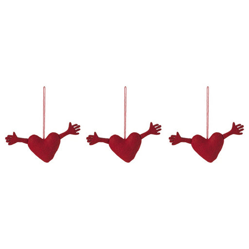 Set of three IKEA VINTERFINT heart-shaped red ornaments with outstretched arms, suspended by red strings against white background