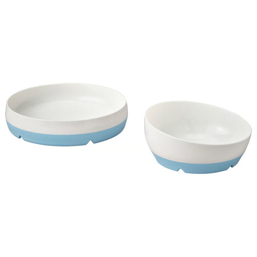 Two white bowls with blue bottoms on a white background