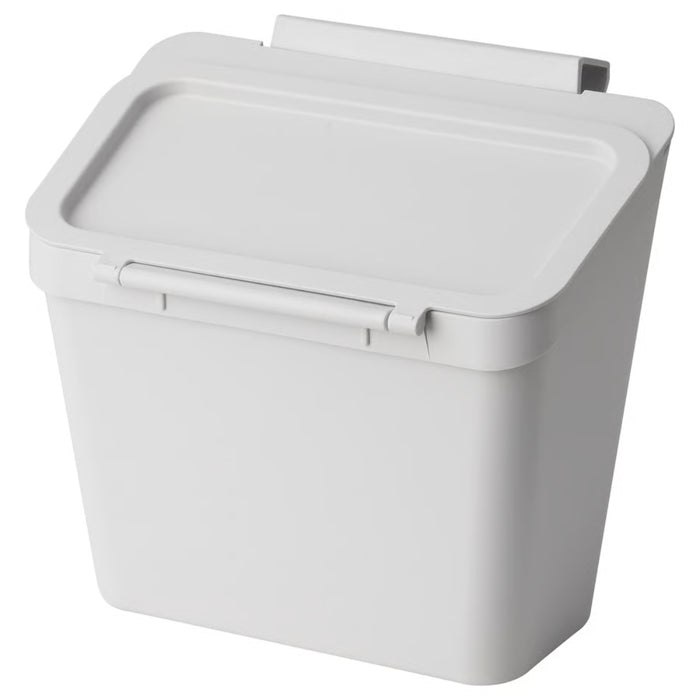 IKEA SKOLÄST waste bin mounted inside a kitchen cabinet door, light grey color