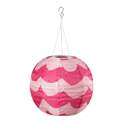 Pink and white patterned paper lantern hanging on a white background