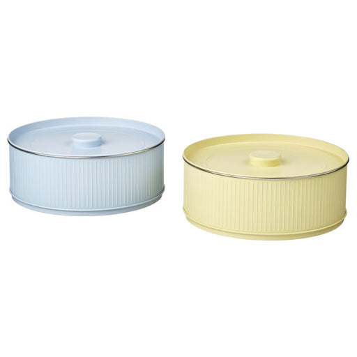 Two cylindrical containers with lids, one light blue and one yellow, on a white background.