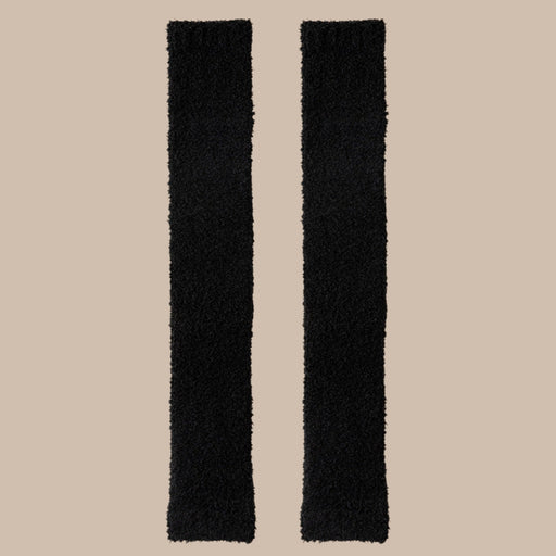 Pair of black plush fabric strips laid flat, showcasing soft texture and length
