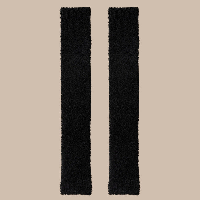 Pair of black plush fabric strips laid flat, showcasing soft texture and length