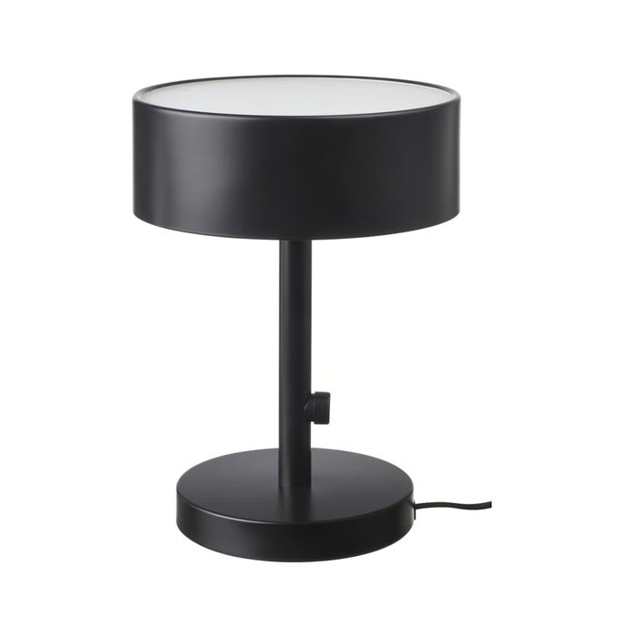 Black table lamp with a white base on a white background