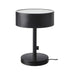 Black table lamp with a white base on a white background