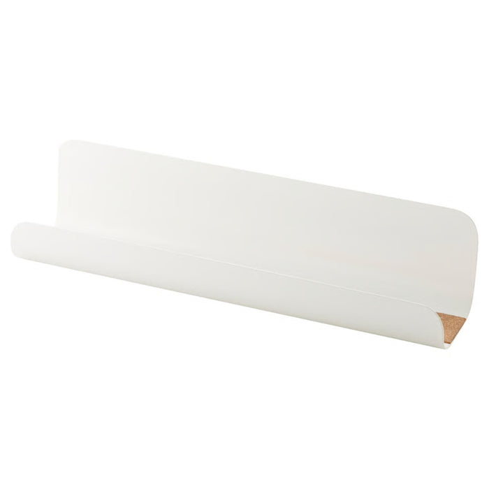 A minimalist white metal wall shelf with a curved front lip and cork lining on the bottom surface, designed for modern interiors and practical storage.