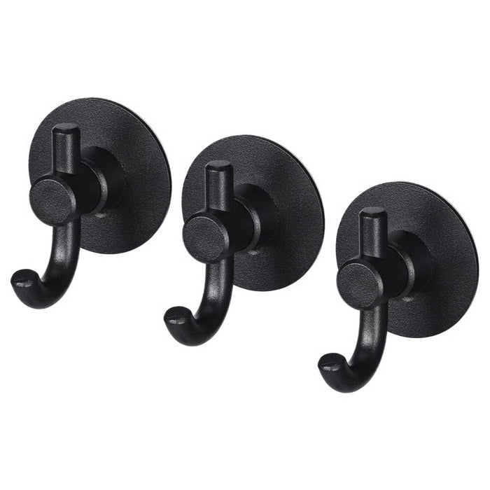Set of three IKEA VALASJÖN self-adhesive hooks in matte black, each with circular base and curved peg for hanging