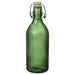 Green glass bottle with a white cap on a white background