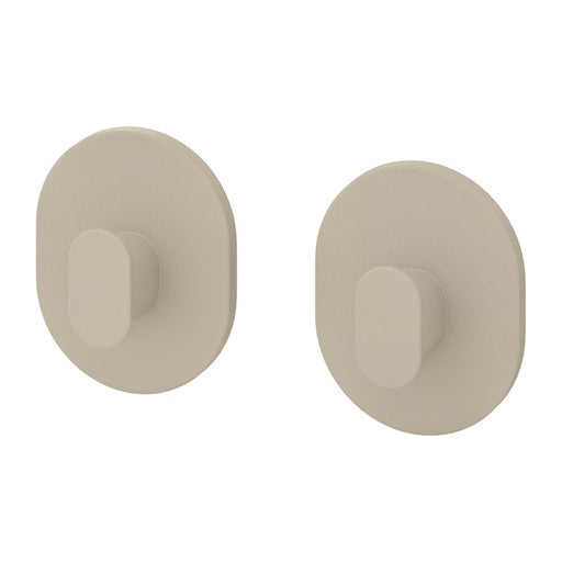 Two beige wall hooks on a white background