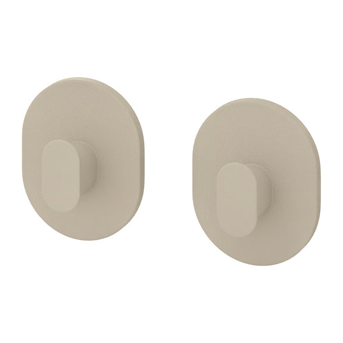 Two beige wall hooks on a white background