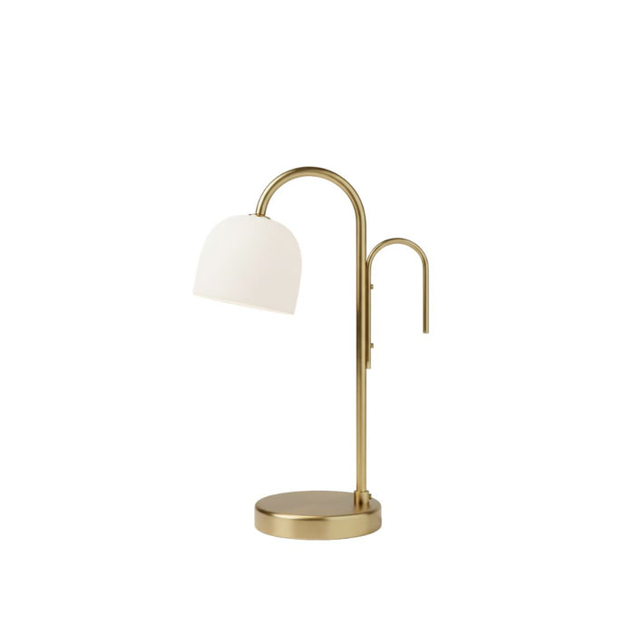 Table lamp with white shade and gold metal base on a white background