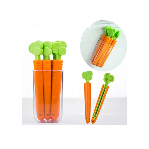 Carrot-shaped tools with green tops in a clear plastic container on a white background.