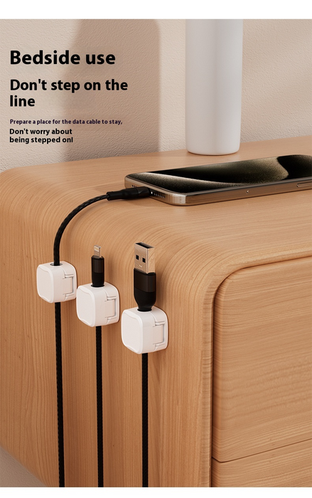 Close-up of single magnetic cord holder gripping USB and power cables