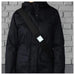 IKEA BESKYDDA reflective clip blue variant clipped onto a dark jacket fabric close-up
