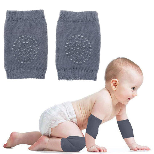 Baby anti-slip knee pads – infant wearing grey pads on knees and elbows while crawling on soft surface