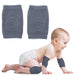 Baby anti-slip knee pads – infant wearing grey pads on knees and elbows while crawling on soft surface