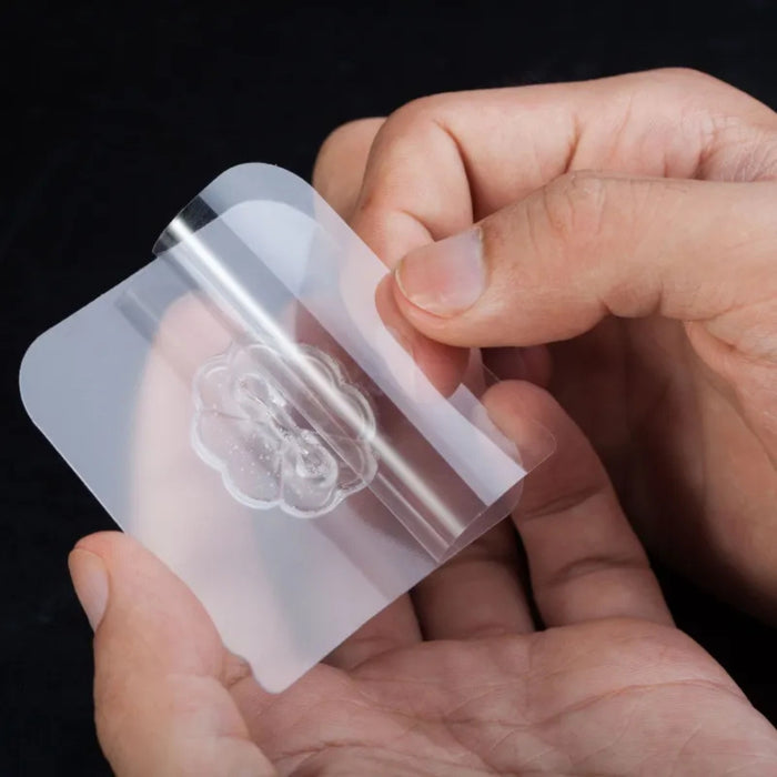 Hands holding a clear plastic sheet with a brain illustration on a black background