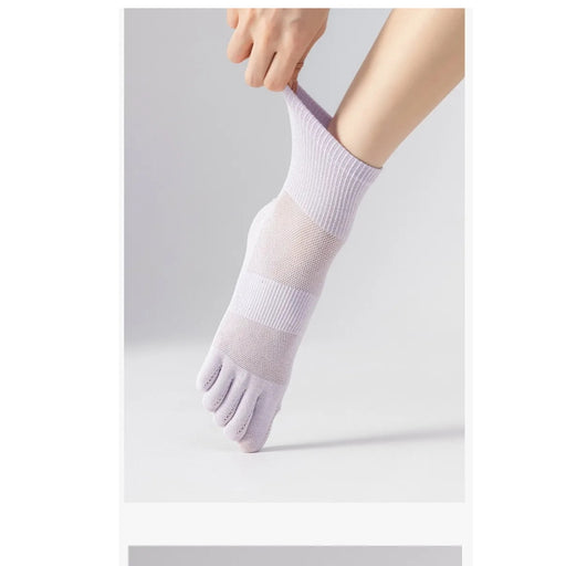 Person wearing a pair of five-finger socks on a light gray background