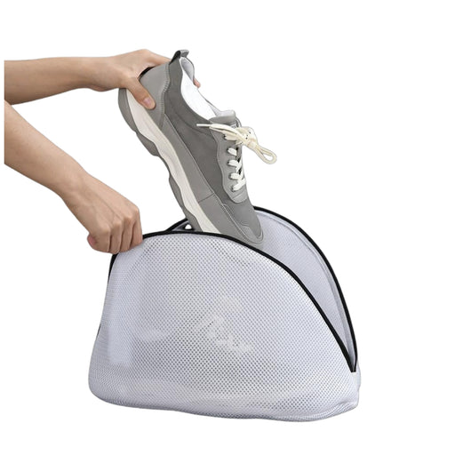 Digital Shoppy laundry bag – sneaker being placed into mesh zippered bag for protective machine washing