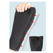 Black shoe insole with red arrows pointing to features, held by a hand against a light blue background