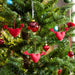 VINTERFINT heart ornaments hanging on a decorated Christmas tree alongside red and blue baubles, adding festive charm