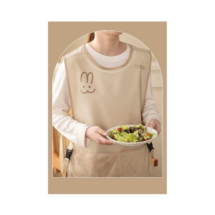 Person wearing a beige apron holding a plate of salad, with a bunny design on the apron.