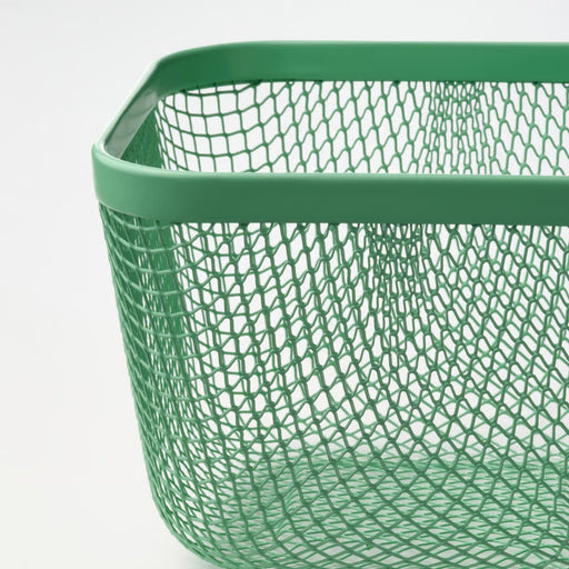 Green wire basket on a white background