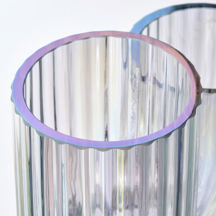 Clear glass vase with a purple rim against a white background