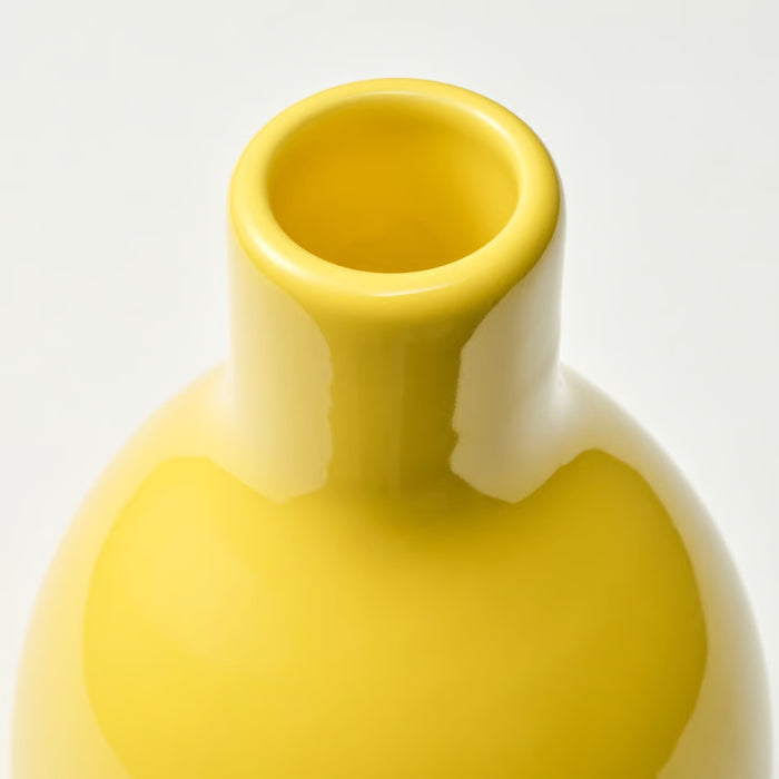 Yellow ceramic vase on a light gray background