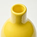 Yellow ceramic vase on a light gray background