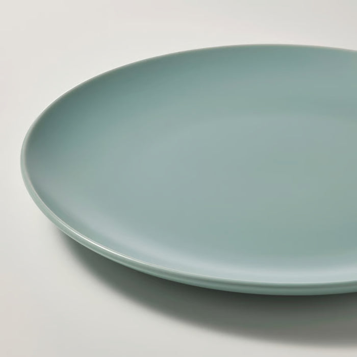 Green ceramic plate on a white background