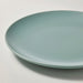 Green ceramic plate on a white background
