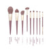 Set of makeup brushes with purple handles on a white background