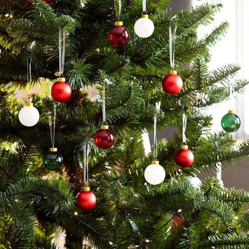 “Assorted glass ornaments, 3.5 cm, arranged in rows of red, green, white, and copper, each with a gold cap and loop for hanging.”