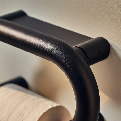 Close-up of a black metal handle on a piece of furniture.