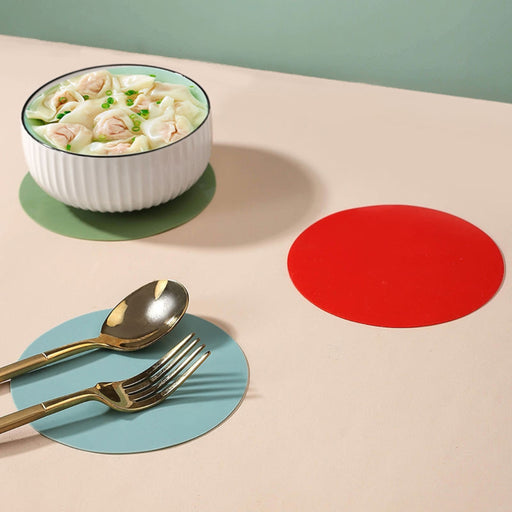 red silicone round mat used as trivet for hot pot